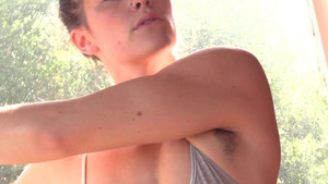 Slim girl with small boobs stretches her naked body alone