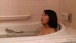 Japanese wife serves a bald man in the living room