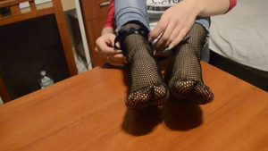Mother shows her perfectly shaped feet and toes by putting them on the table