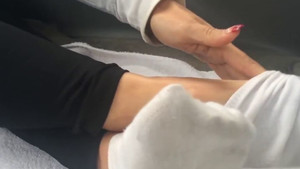 Mature girl shows off her feet by taking off her sneakers and her socks as well